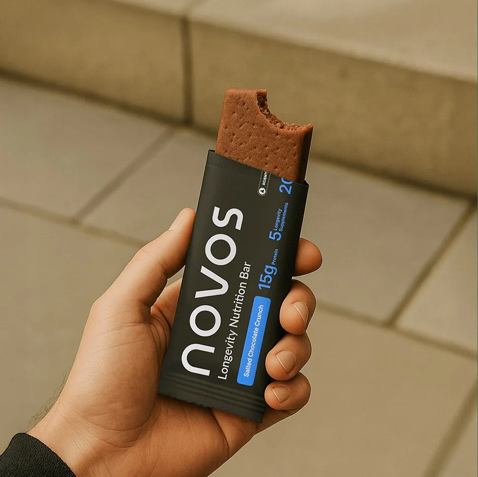 Hand holding an opened NOVOS Bar