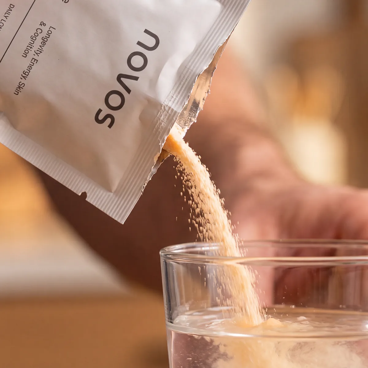 A NOVOS Core pack being poured into a glass of water